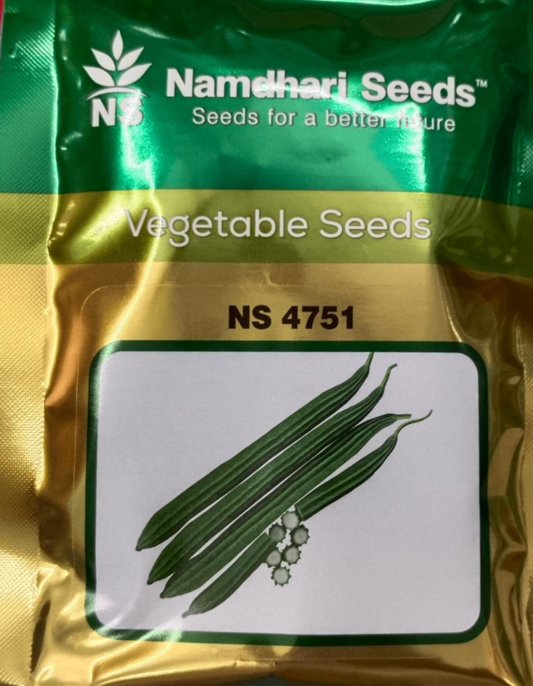 NS 4751 F1 Hybrid Ridge Gourd seeds pack with label, high-yielding hybrid variety for uniform, tender ridge gourd production in vegetable farming